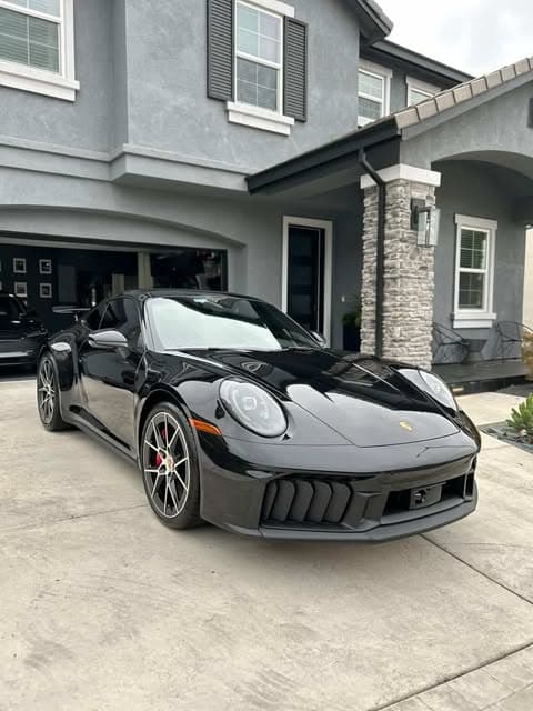 Black Porsche 911 with restored, defect-free paint after Gold Grade paint correction